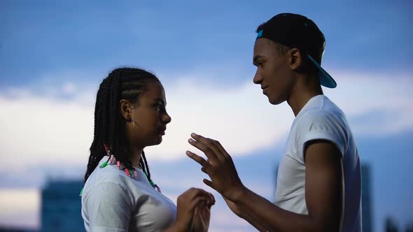 Teenage Couple Putting Foreheads Together, Holding Hands, Full Trust Concept