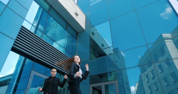 Colleagues, Students Wear Classic Suits, Dance Celebrate Outdoor, Against Backdrop of Blue Glass