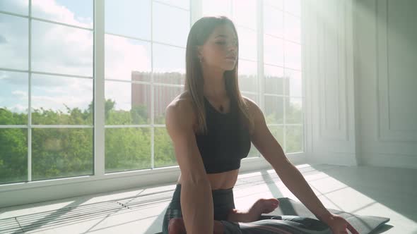 Wellness, Young Female Meditates and Does Yoga, a Calm Mood, Relaxing in a White Room