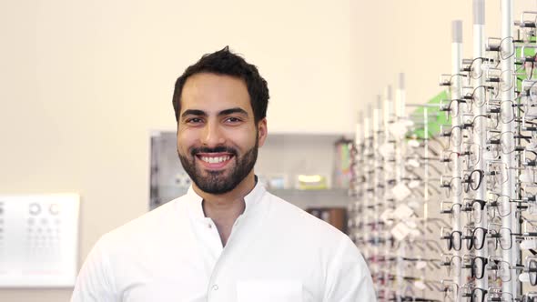 Optician Doctor Near Showcase With Eyeglasses At Glasses Shop