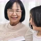 Happy Asian grandmother and lovely girl reading book together. - VideoHive Item for Sale