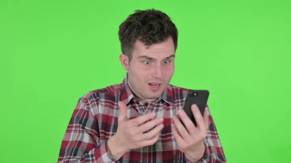 Portrait of Young Man Loss on Smartphone Green Chroma Screen