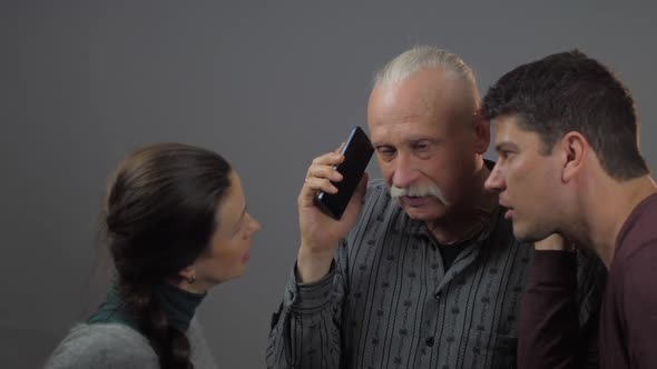 Lady and Men Holding Modern Smartphone Listening To Phone