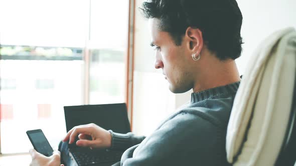 Man using smatphone and computer