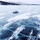 A Hovercraft Rides on the Blue Icy Lake Baikal Covered with White Snow Panoramic Aerial Shot - VideoHive Item for Sale