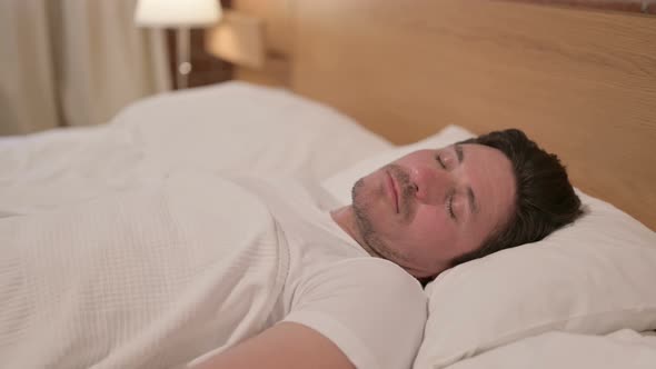 Middle Aged Man Sleeping in Bed Peacefully