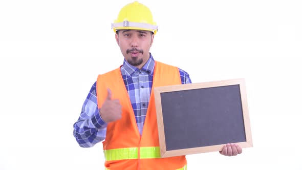 Happy Bearded Persian Man Construction Worker Holding Blackboard and Giving Thumbs Up