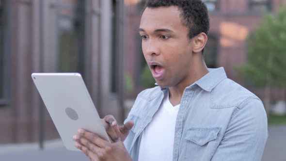 Wow, Surprised African Man Using Tablet in shock