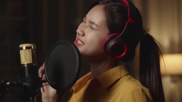 Close Up Young Asia Girl Singing In Home Studio