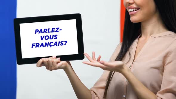 Do You Speak French on Tablet Screen in Female Hand, Language Studying App