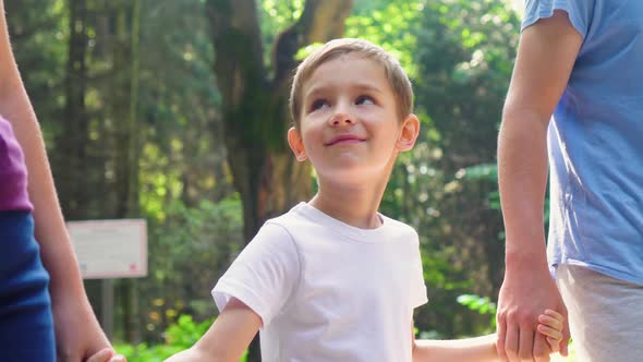 A Family of Three is Walking in the Park