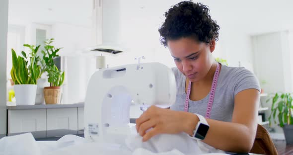 Woman stitching clothes on sewing machine 4k