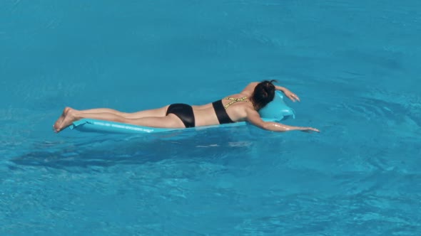 Woman Swimming on a Blue Water Pool