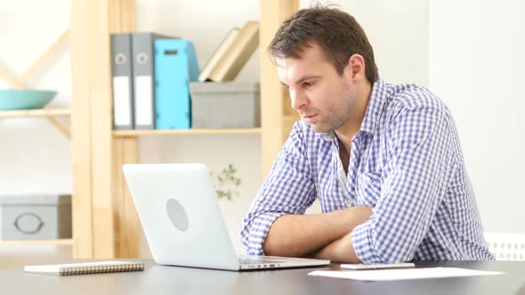 Man Looking Toward Camera at Work