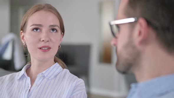 Close Up of Attractive Young Woman Talking To a Man