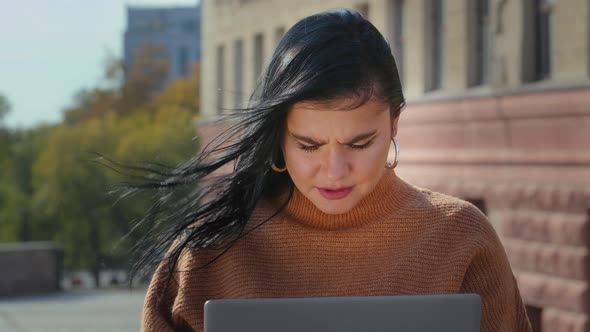 Closeup Young Focused Serious Woman Working on Laptop Reading Bad News Looks Desperate Feels Sad