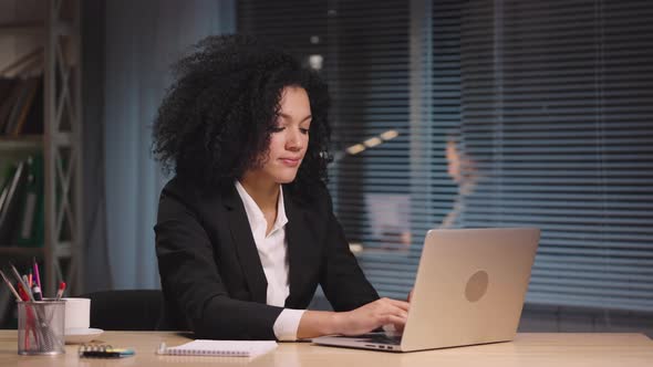 Portrait of African American Woman Finishes Work Closes Laptop and Relaxes By Closing His Eyes