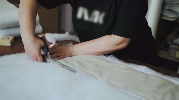 Female Worker Cutting Foam Rubber with Scissors for the Production of a Sofa in a Furniture Factory