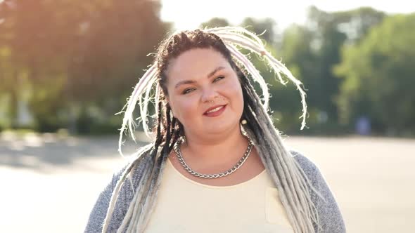 Concept of Diverse Beauty and Lifestyle. Portrait of Happy Smiling Woman with Dreads Posing for