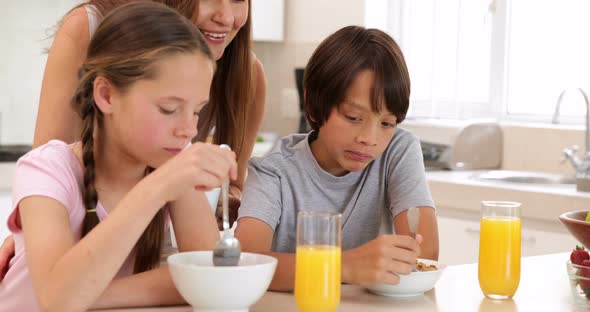 Brother and sister eating cereal together