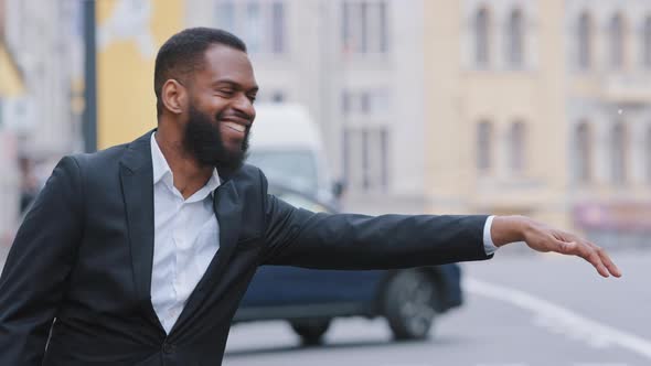 Smiling Cheerful Benevolent Young Adult Man Wearing Formal Clothes Signaling Driver to Stop Leave By