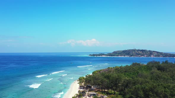 Luxury birds eye tourism shot of a summer white paradise sand beach and blue ocean background in col