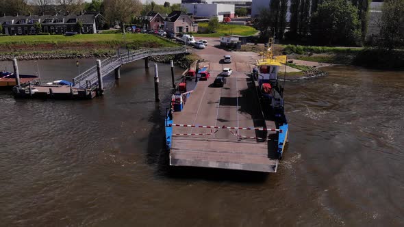 Vehicles Driving Out On Ferry Service In De Lek River In Kinderdijk, Netherlands. - aerial