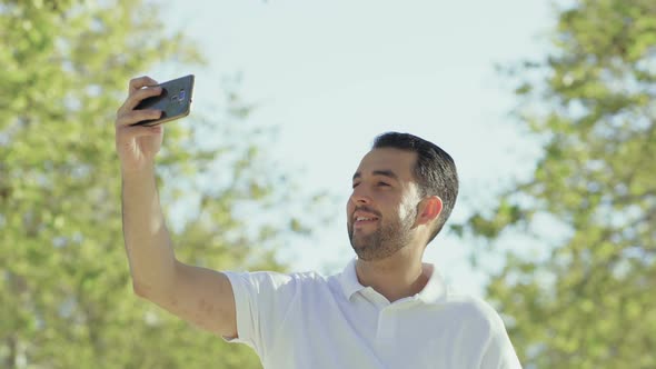 Handsome Young Man Having Video Call Through Phone