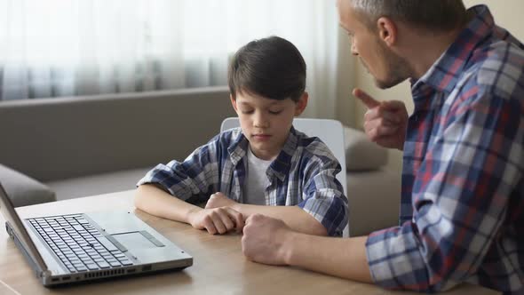 Strict Father Scolding His Little Son for Computer Addiction, Family Problem