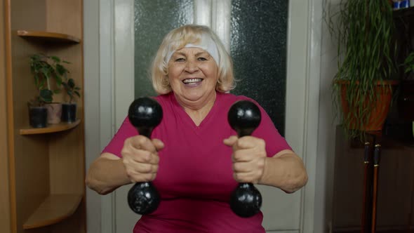 Senior Mature Grandmother Woman Doing Weightlifting Training Workout Dumbbell Exercising at Home