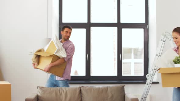 Happy Couple with Stuff Moving To New Home