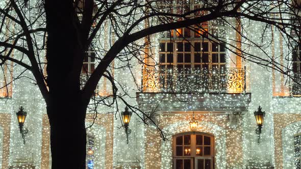 Glowing garland decoration of house facade.