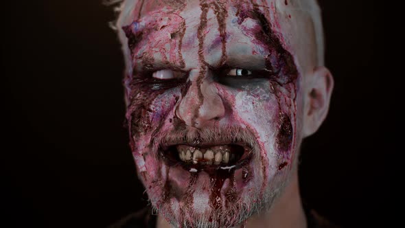 Zombie Man Face Makeup with Wounds Scars and White Contact Lenses Blood Flows and Drips on Face