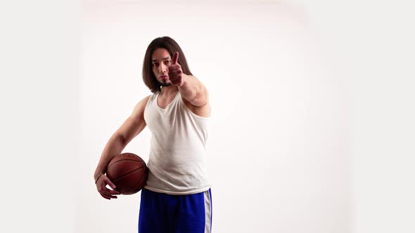 Man at His 20s Showing Like While Holding a Basketball in His Arm