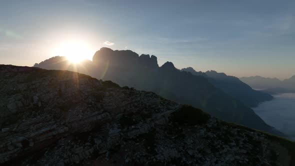 Female and male hikers at the top of the mountain at sunrise.