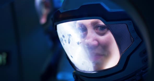 Female Astronaut Looking Out of Spaceship Porthole