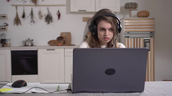 Young Business Woman Student Wear Wireless Headset Video Conference Calling on Laptop Computer