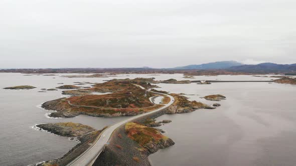 Magnificent Aerial View Of Long, Narrow, And Curved Atlantic Ocean Road In Norway - aerial shot