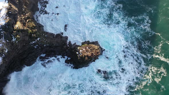 Drone Captures the Majestic Icelandic Ocean Waves Upwards from a Top Down View