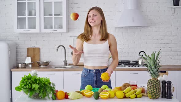 Pretty woman in her kitchen. Portrait of smiling young housewife in modern kitchen