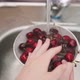 Young woman hands wash cherries in bowl over metal sink - VideoHive Item for Sale