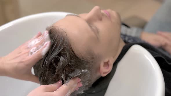 Hands Washing Hair with Shampoo