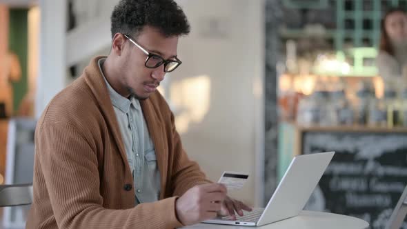 African Man Upset By Online Payment Failure on Laptop