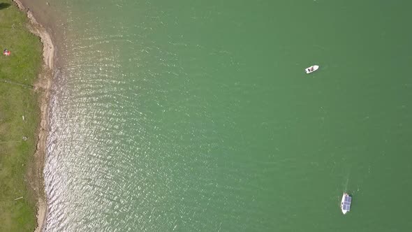 Aerial Top Downshot of boats on lake water