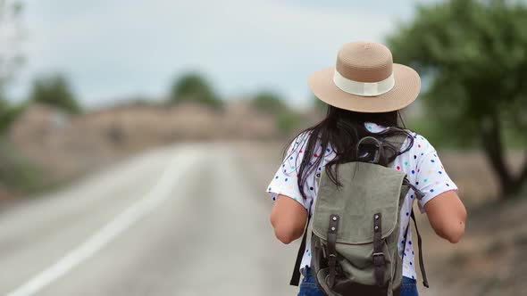 Girl with Backpack Go on Driveway Surrounded By Natural Park