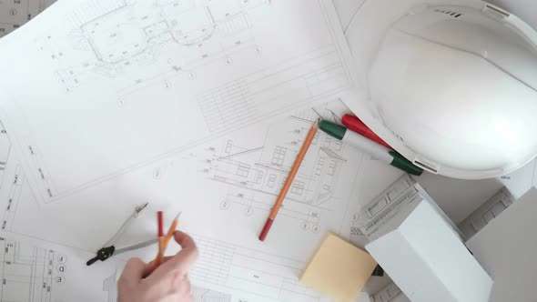 Closeup of a Large Table on Which Lay the Pencils and Markers and a Helmet, Hand Sorted Large