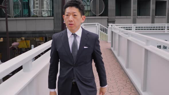 Japanese businessman walking in Tokyo