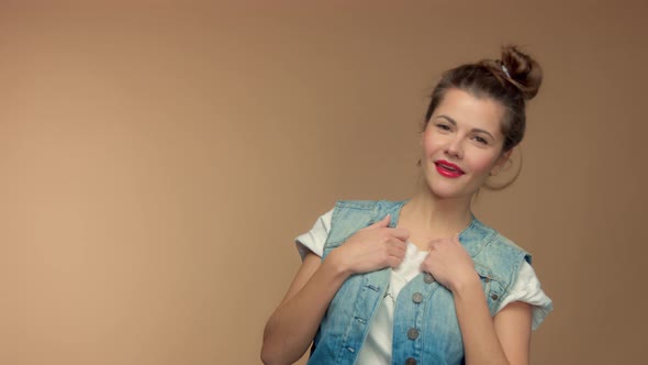 Caucasian Woman in Studio on Beuge Background Have Fun and Poses To Camera