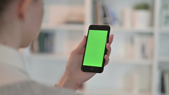 Rear View of Woman Using Smartphone with Chroma Key Screen 