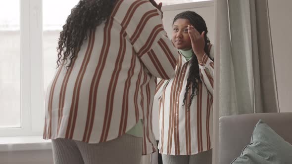 Woman Looking at Herself in Mirror
